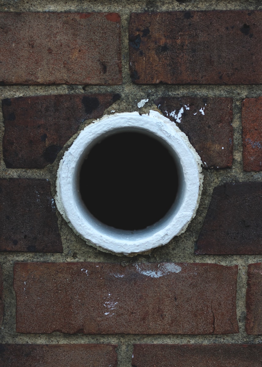 white hole in brick wall
